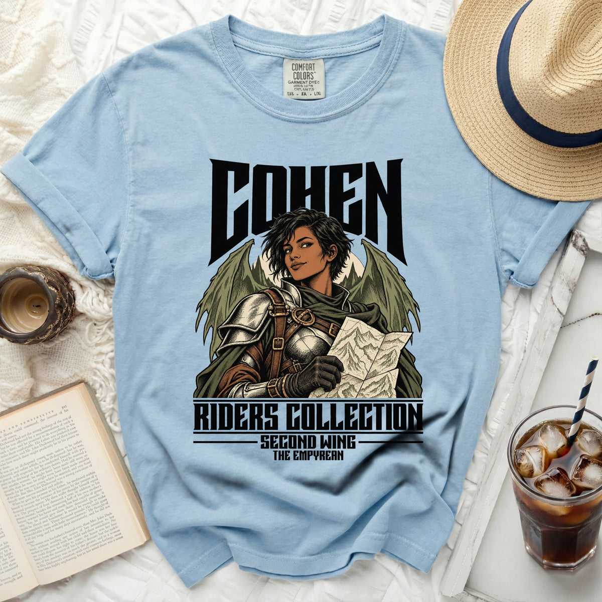 Light blue t-shirt with "COHEN RIDERS COLLECTION SECOND WING THE EMPYREAN" graphic.