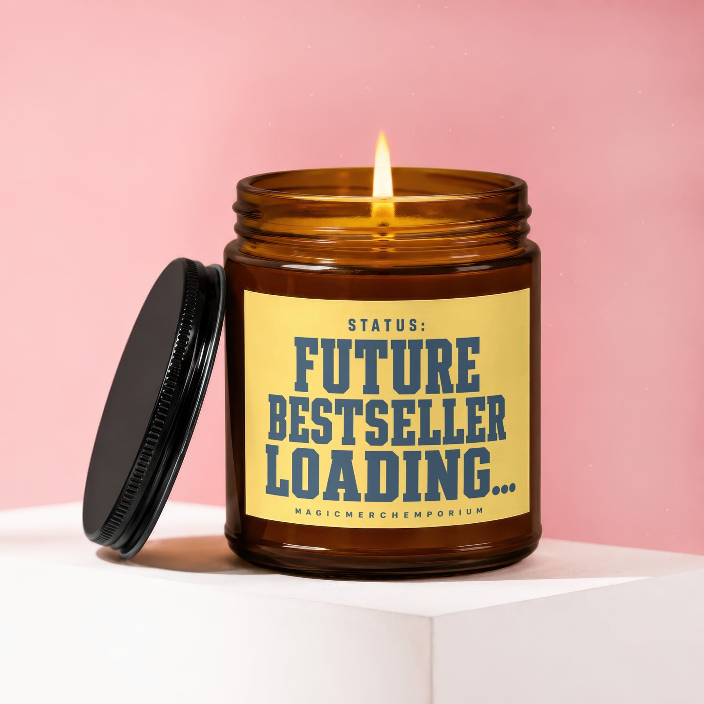 Amber candle with lit wick, label reads "STATUS: FUTURE BESTSELLER LOADING...".