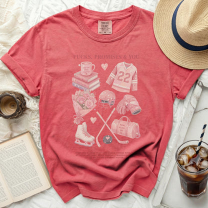 T-shirt with hockey and book illustrations, text "Pucks, Promises & You."