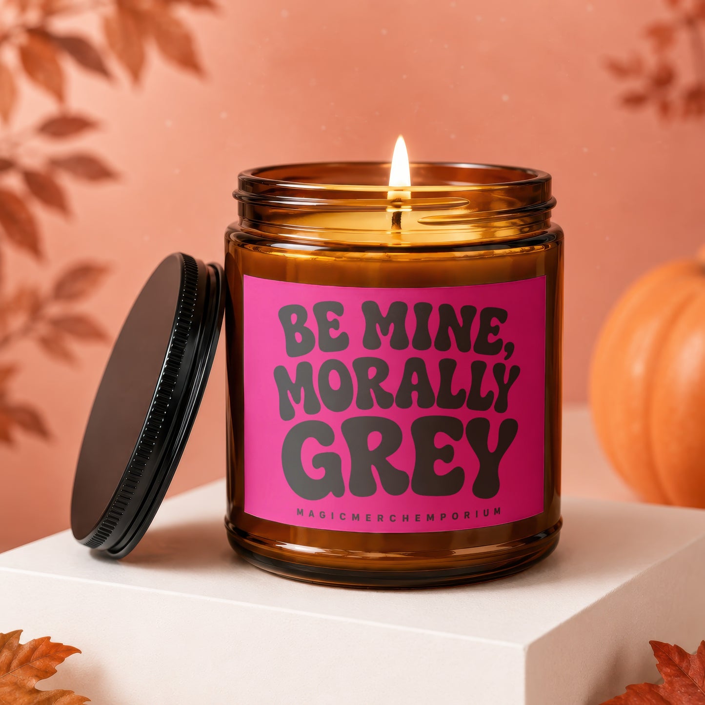 Amber candle with pink label that reads "BE MINE, MORALLY GREY".