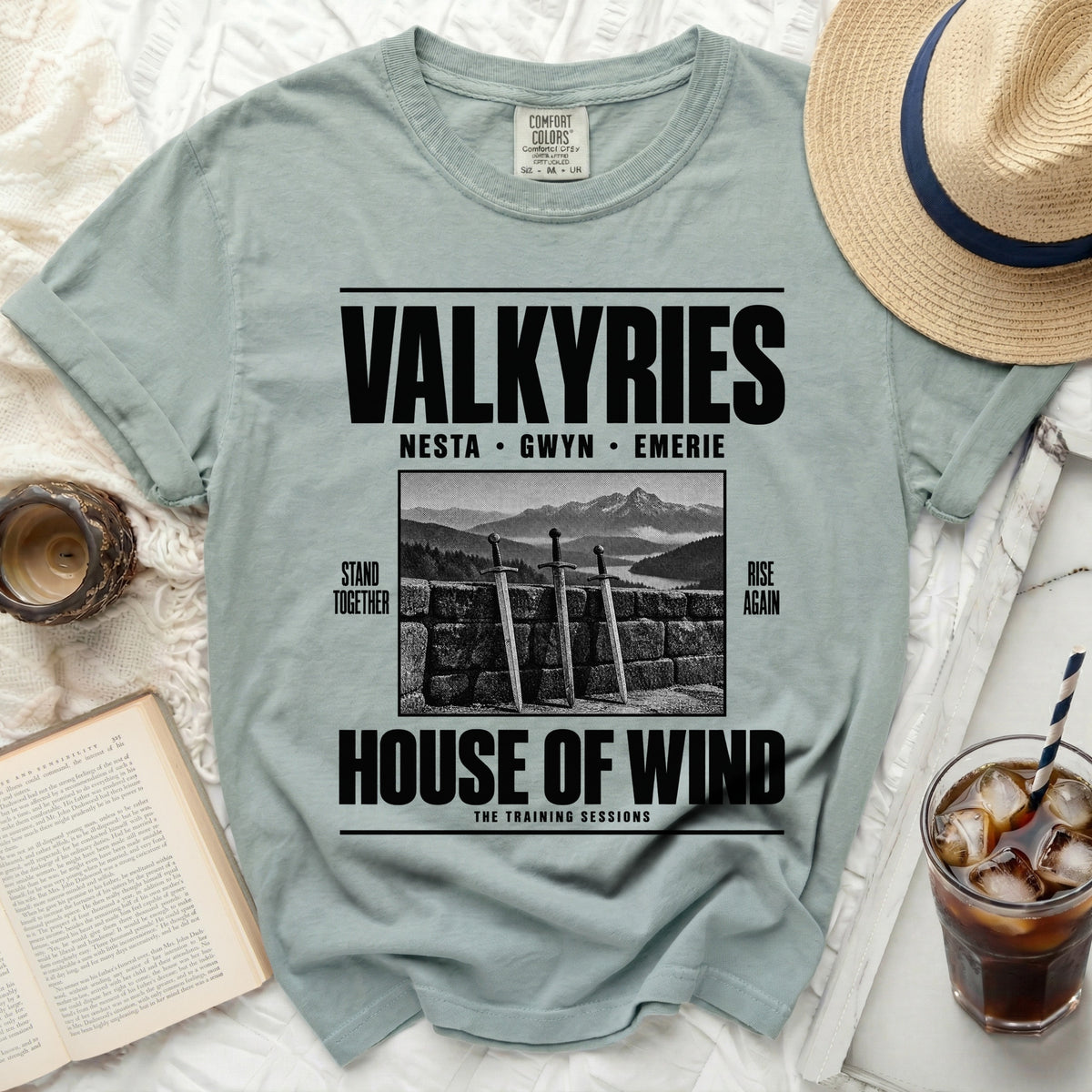 Light green t-shirt with "VALKYRIES" and "HOUSE OF WIND" text, featuring three swords.
