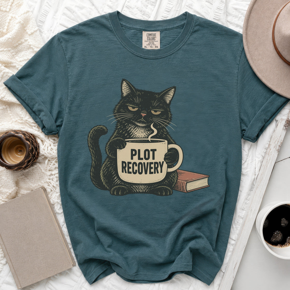 Black cat holding a mug with "PLOT RECOVERY" text beside a book.