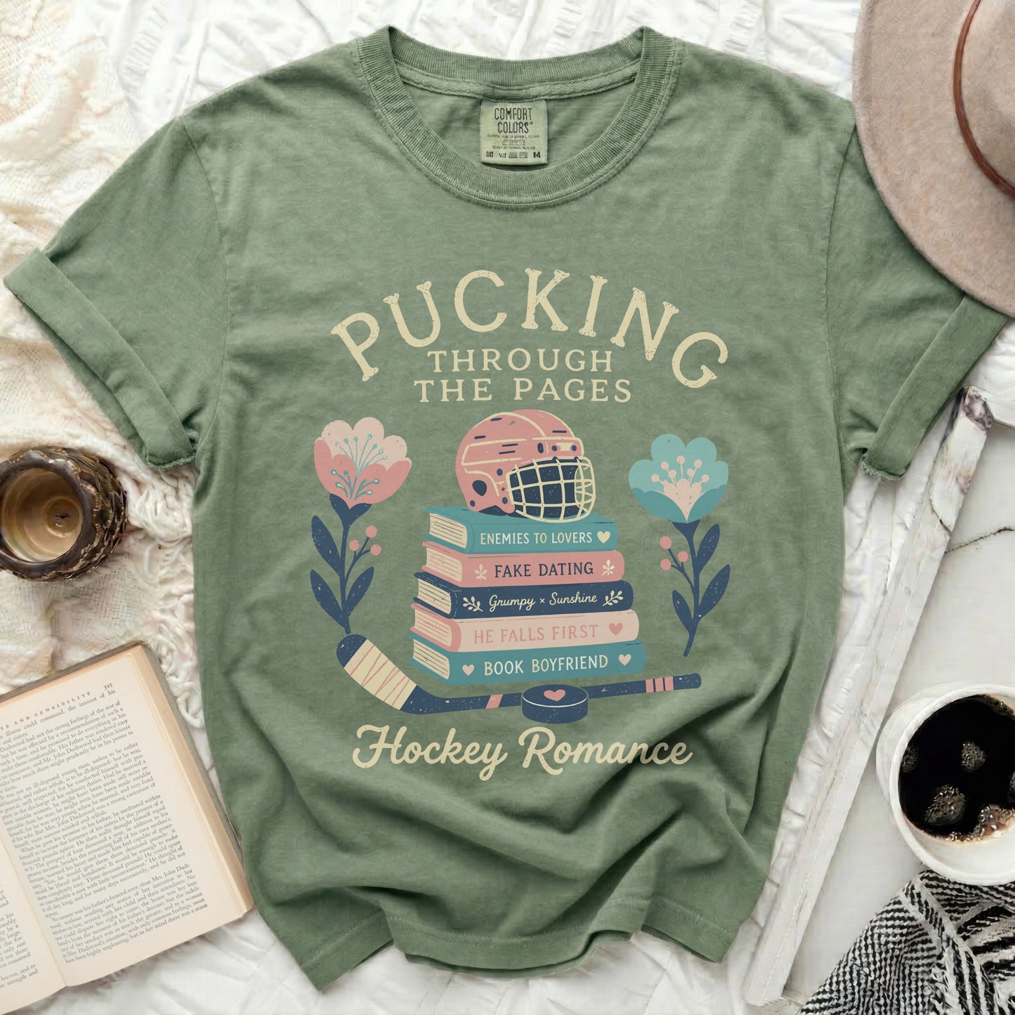Green t-shirt with "Pucking Through the Pages" and hockey romance book titles.