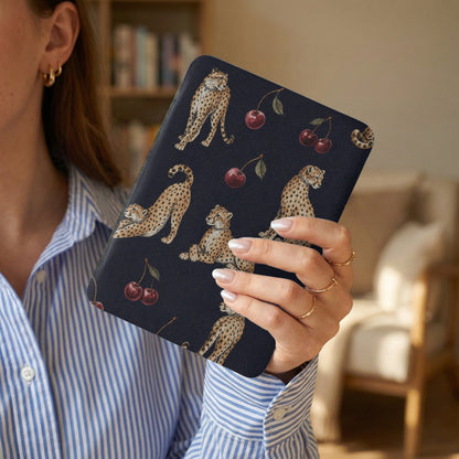 Dark blue cover with cheetahs and cherries pattern, held by a woman.