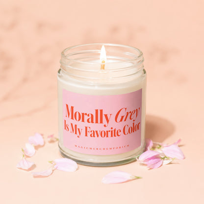 Lit candle in glass jar with pink label reading "Morally Grey Is My Favorite Color".