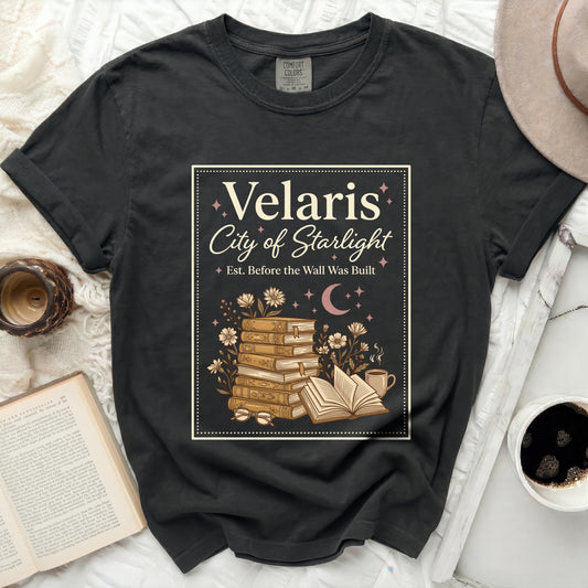Dark gray t-shirt with Velaris City of Starlight graphic, books, and coffee.