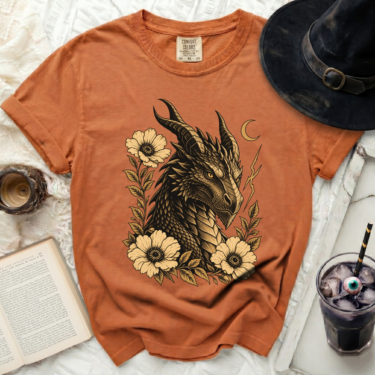 Orange Comfort Colors t-shirt with a vintage dragon and flower graphic.
