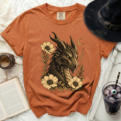 Orange Comfort Colors t-shirt with a vintage dragon and flower graphic.