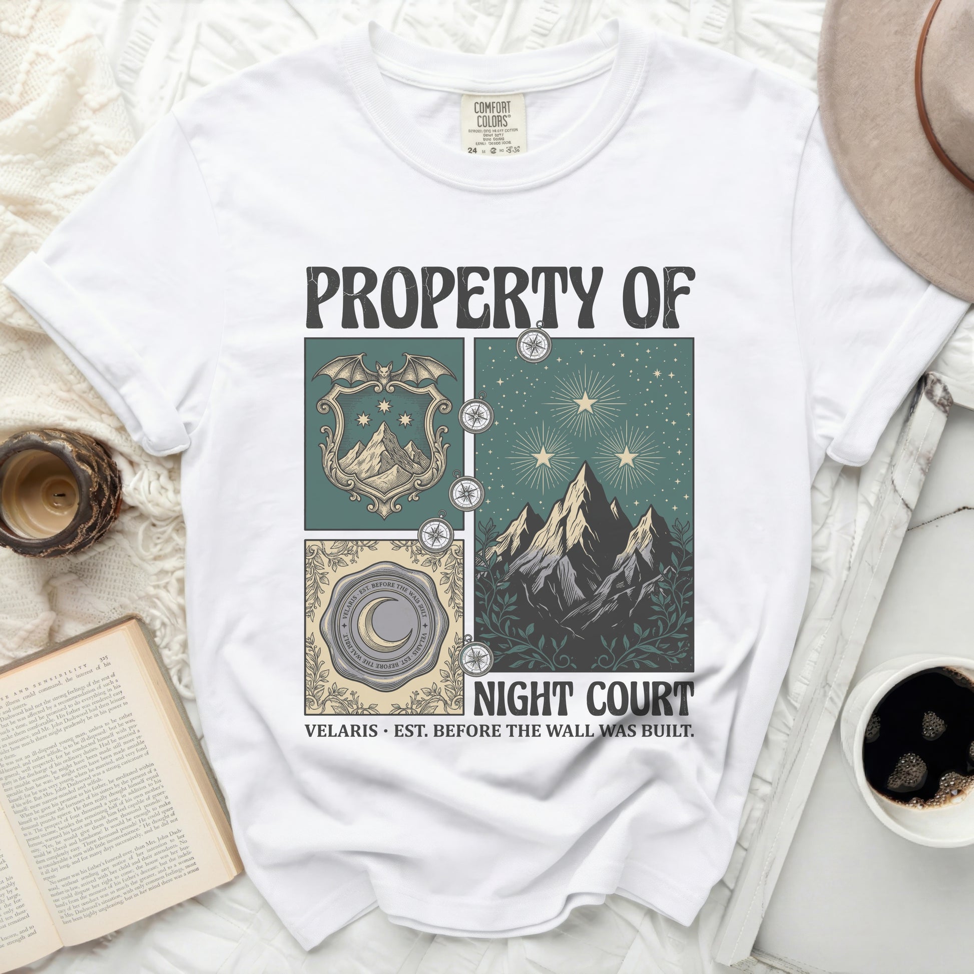 White t-shirt with "PROPERTY OF NIGHT COURT" graphic and moon, stars, and mountains design.