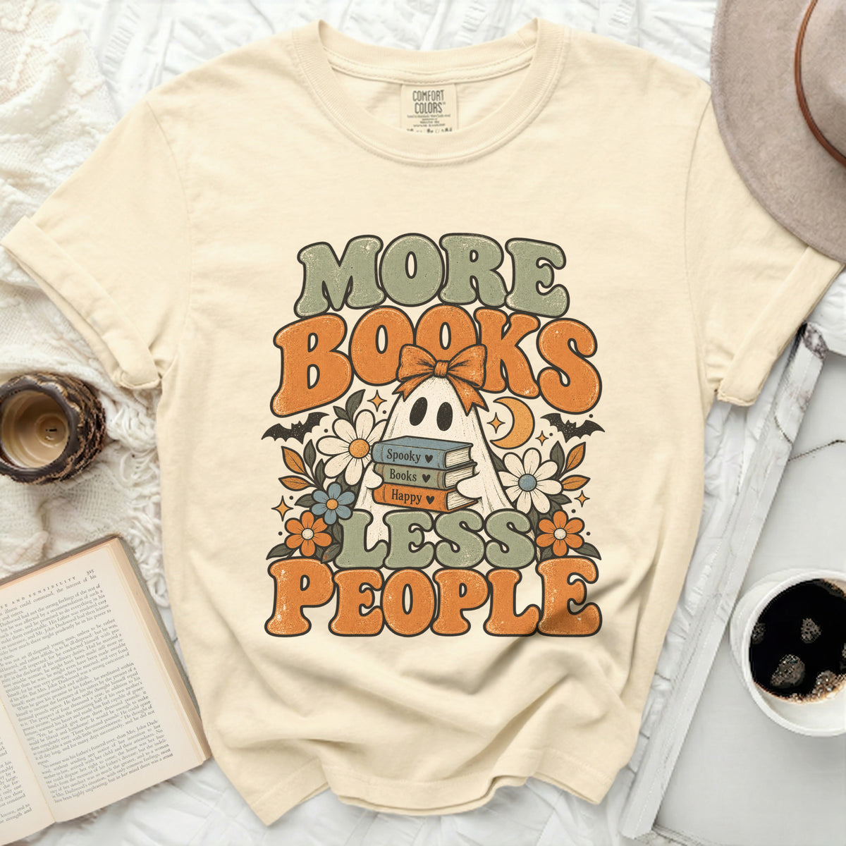 T-shirt with "More Books Less People" text, ghost, and books graphic.