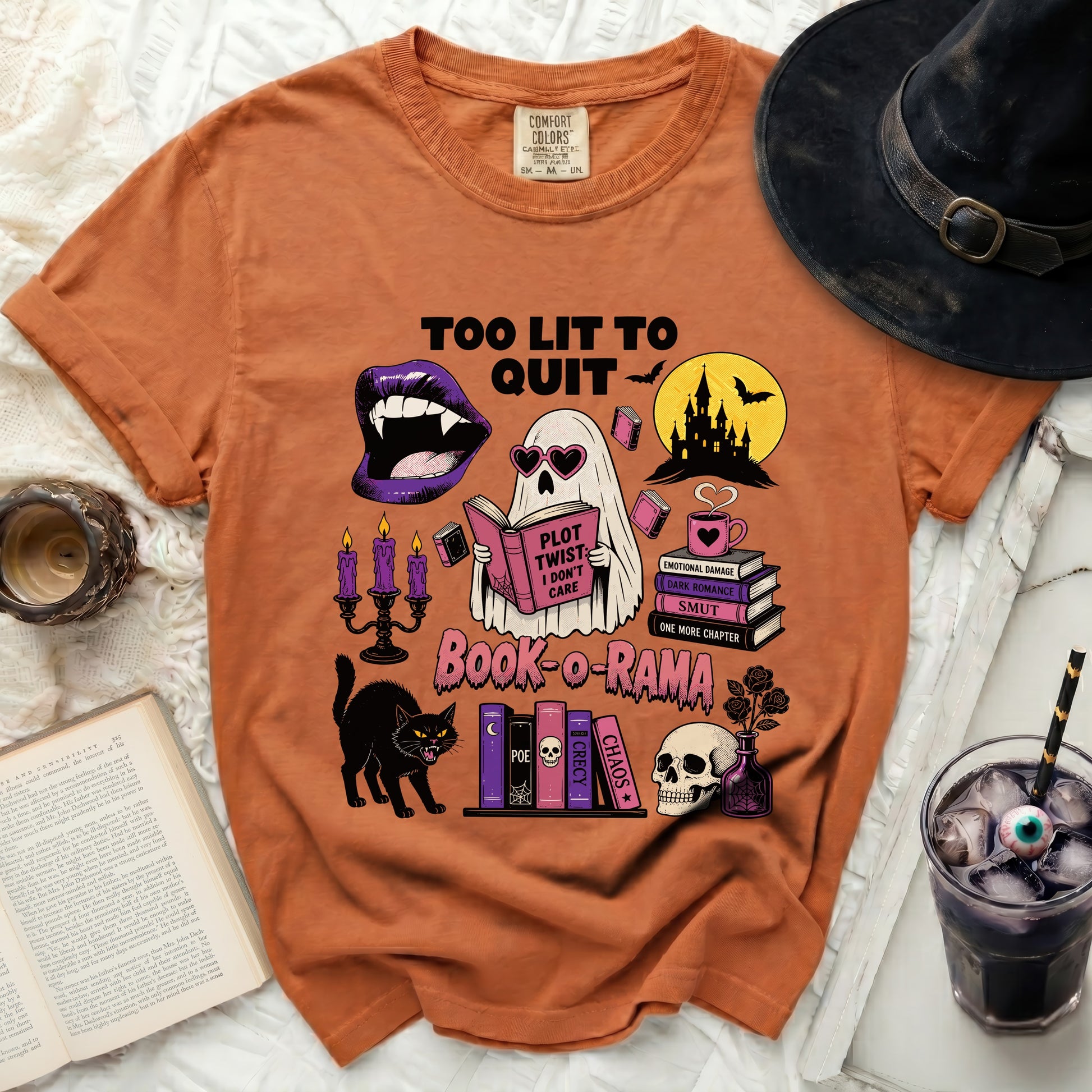 Orange t-shirt with "Too Lit To Quit" and Halloween book graphics.