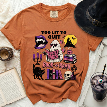Orange t-shirt with "Too Lit To Quit" and Halloween book graphics.