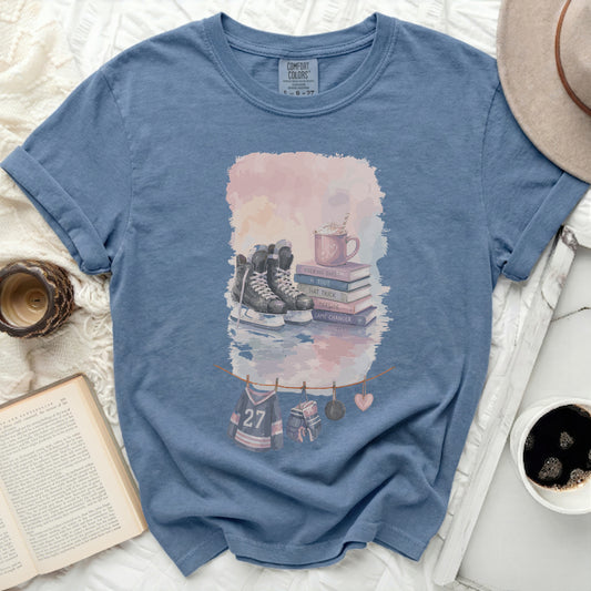 Blue t-shirt with ice skates, mug, and hockey jersey decorations.