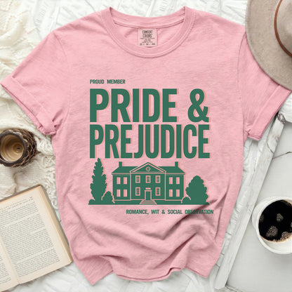 Pink shirt with "Pride & Prejudice" text and house graphic.