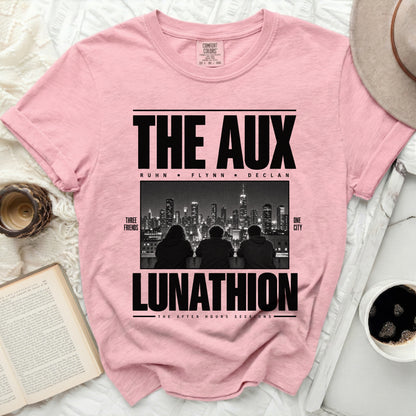 Pink t-shirt with "THE AUX LUNATHION" and city skyline graphic.