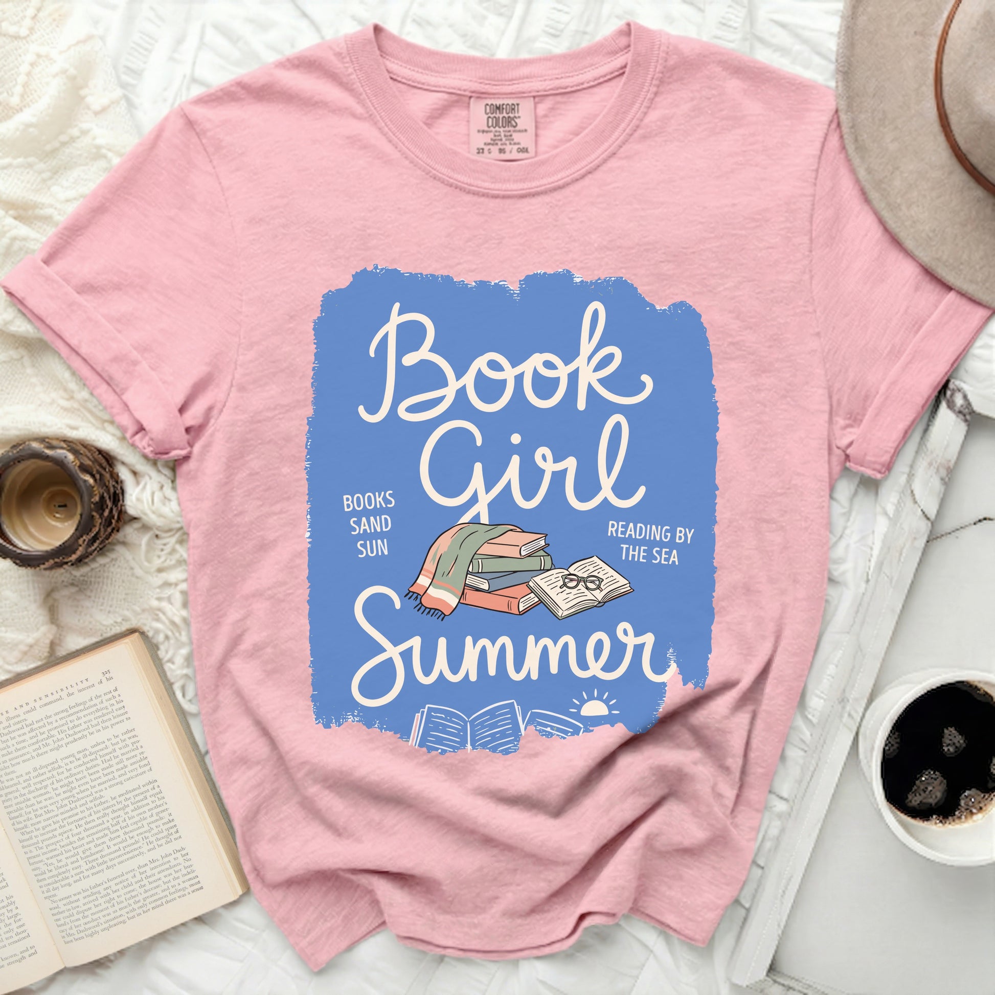 Pink t-shirt with "Book Girl Summer" text and stacked books graphic.