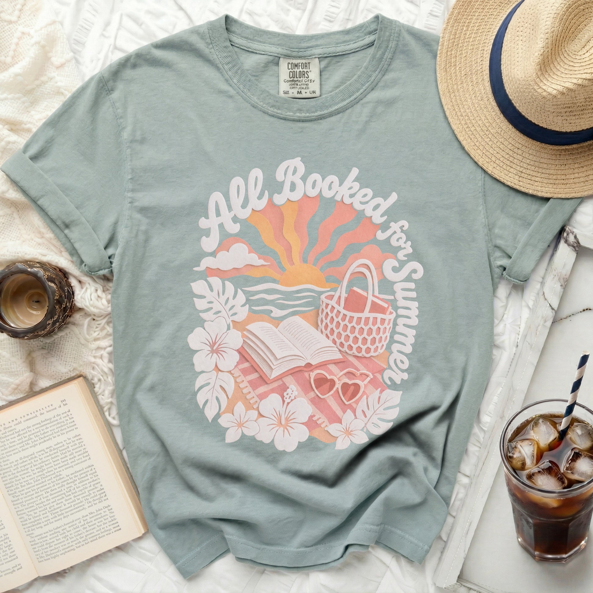 Green t-shirt with "All Booked for Summer" text and beach scene graphic.