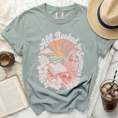 Green t-shirt with "All Booked for Summer" text and beach scene graphic.