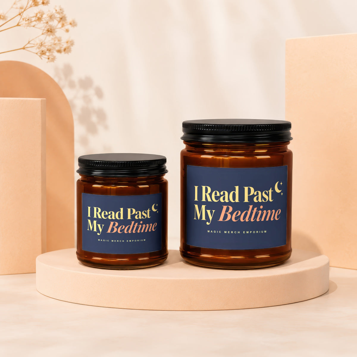 Two amber glass candles with dark lids, labeled "I Read Past My Bedtime".