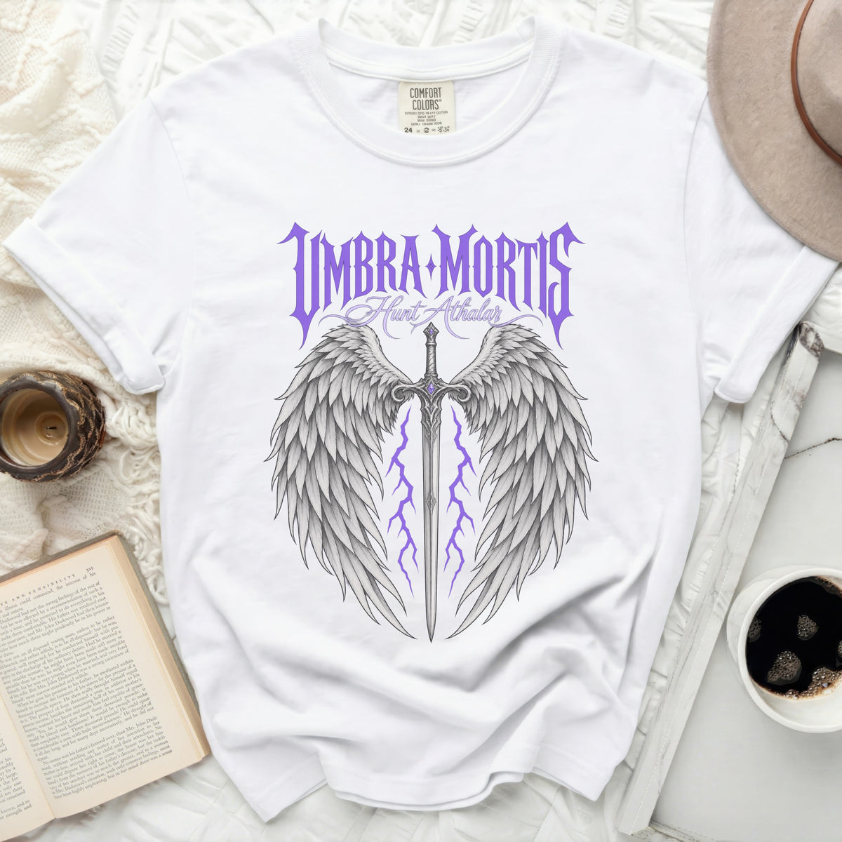 White t-shirt with "Umbra Mortis Hunt Athalar" text, sword, and wings graphic.