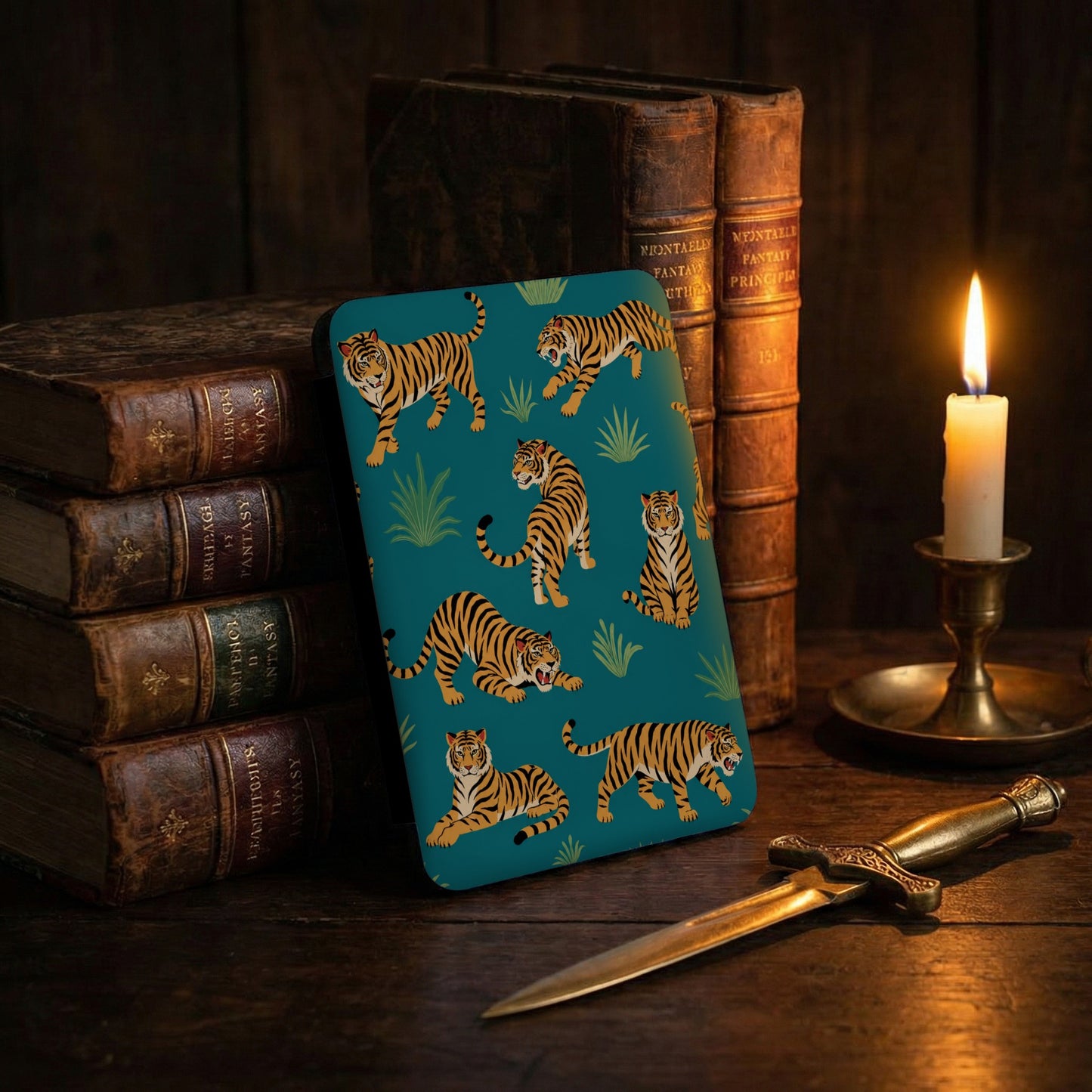 Teal case with tiger illustrations features stacked vintage books and a lit candle.