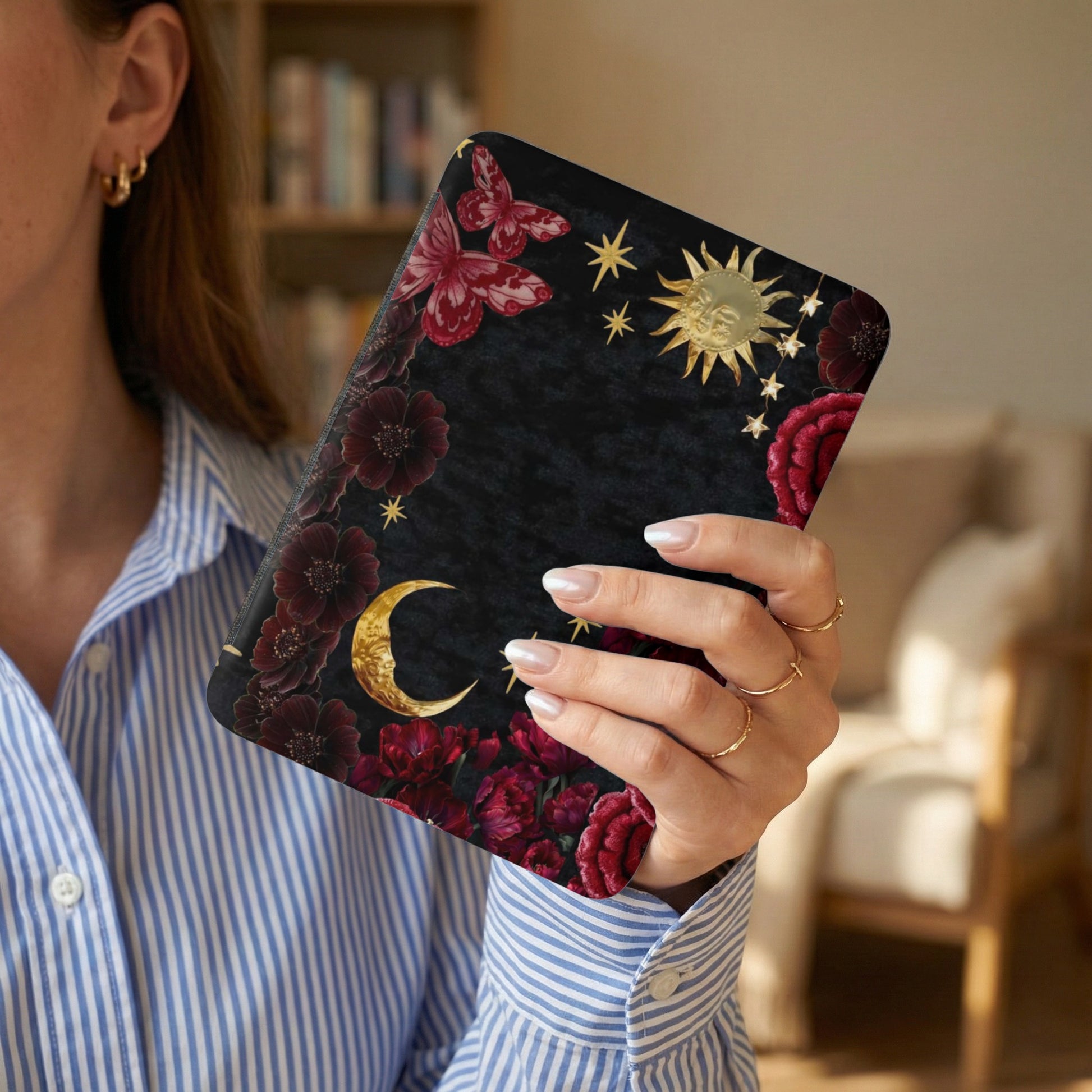 Black celestial design with gold sun, moon, stars, red flowers, and butterflies.