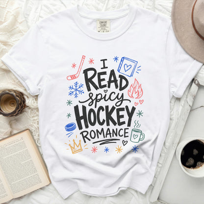 White t-shirt with "I Read Spicy Hockey Romance" graphic and small icons.