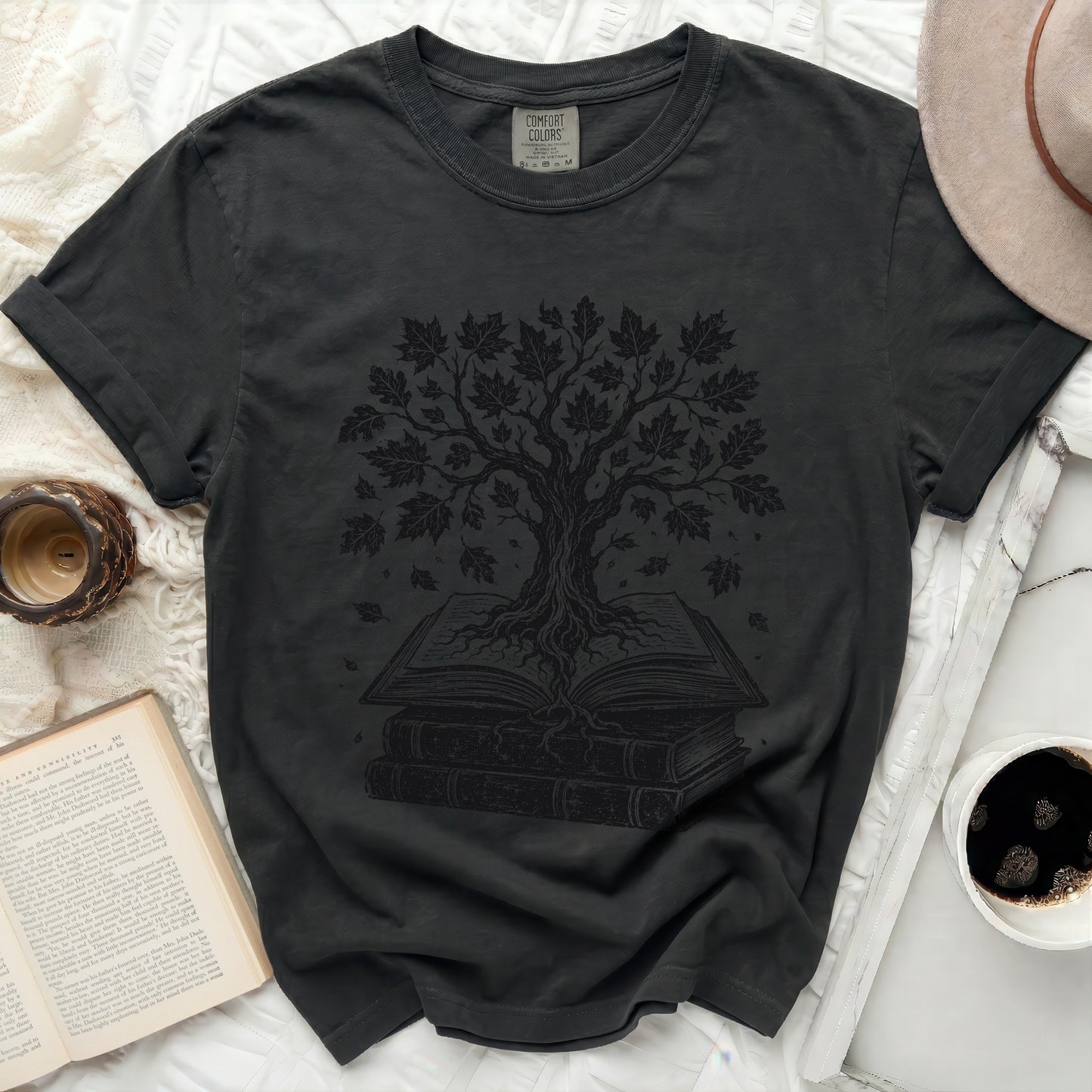 Dark t-shirt with a black tree graphic growing from an open book.