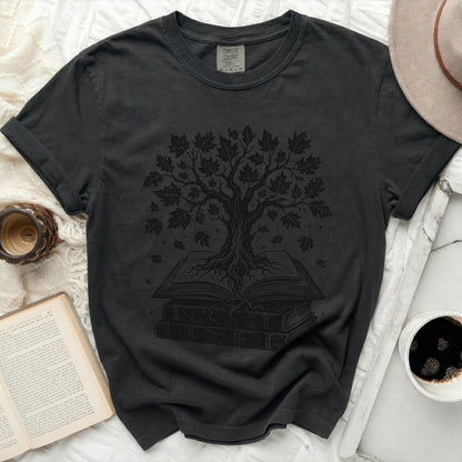 Dark t-shirt with a black tree graphic growing from an open book.