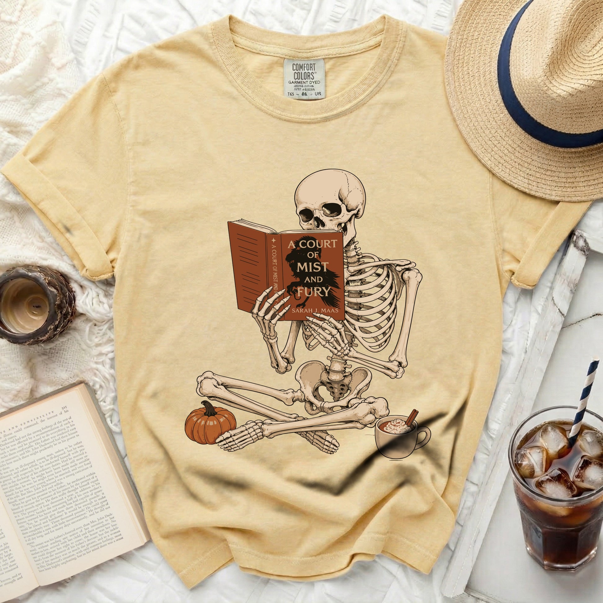 Skeleton reading "A Court of Mist and Fury" by Sarah J. Maas.