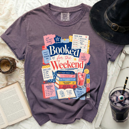 Purple t-shirt with "Booked for the Weekend" and reading-themed graphics.