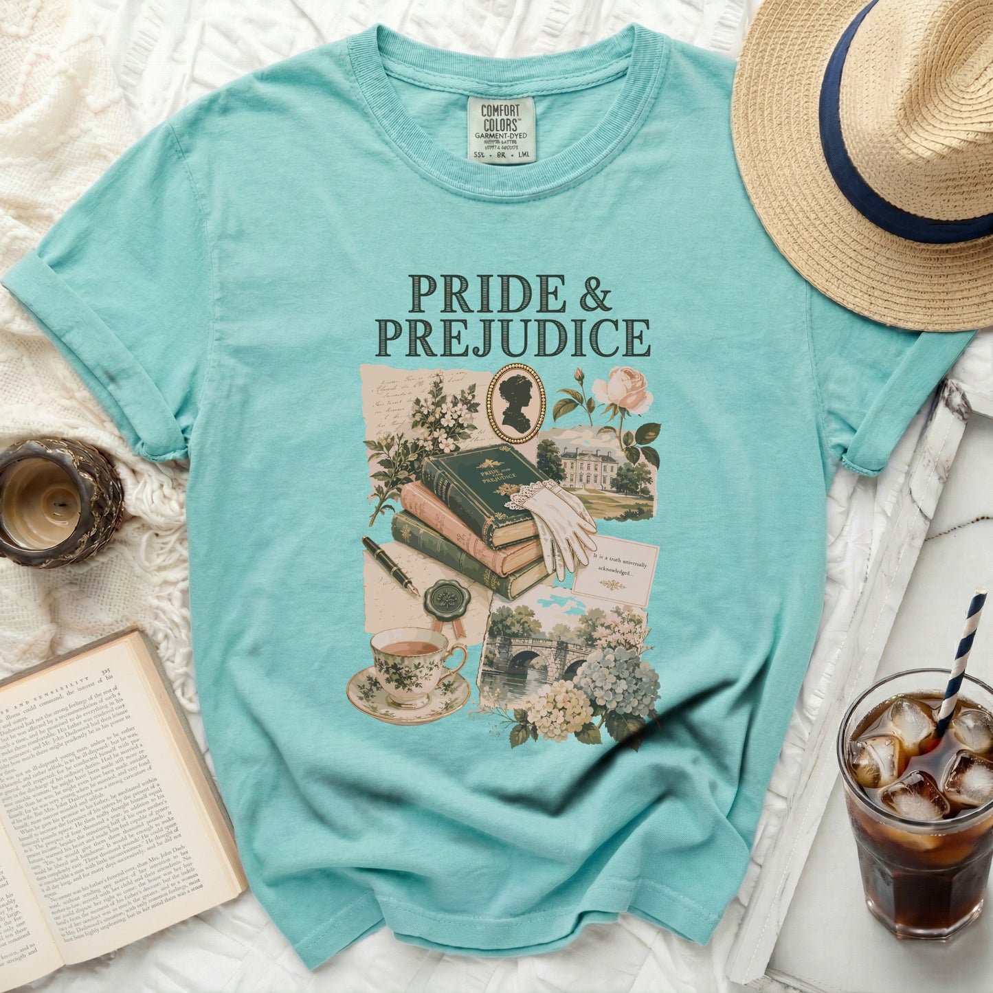 Teal t-shirt with "Pride & Prejudice" text and vintage illustrations of books.