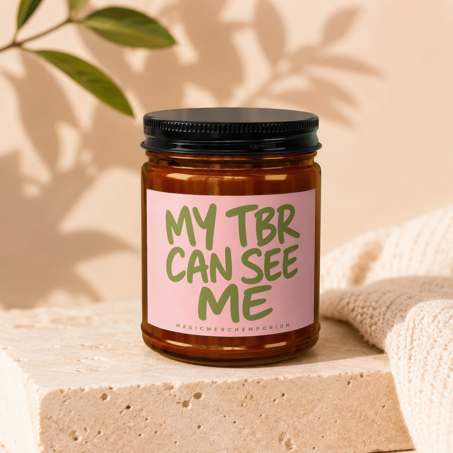 Brown glass candle with a pink label that reads "MY TBR CAN SEE ME".