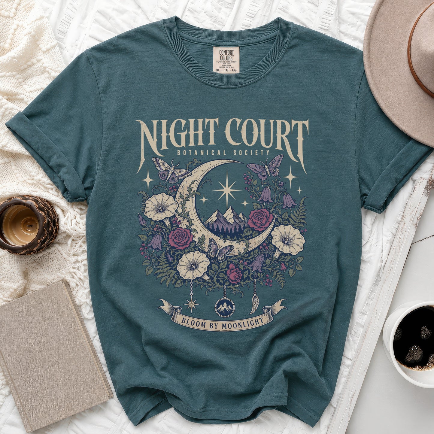 Teal t-shirt with "Night Court Botanical Society" and "Bloom by Moonlight" text and moon design.