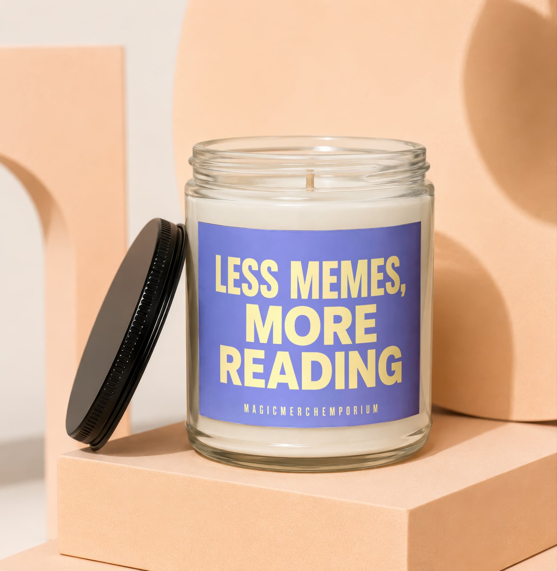 Glass candle with blue label reading "LESS MEMES, MORE READING"