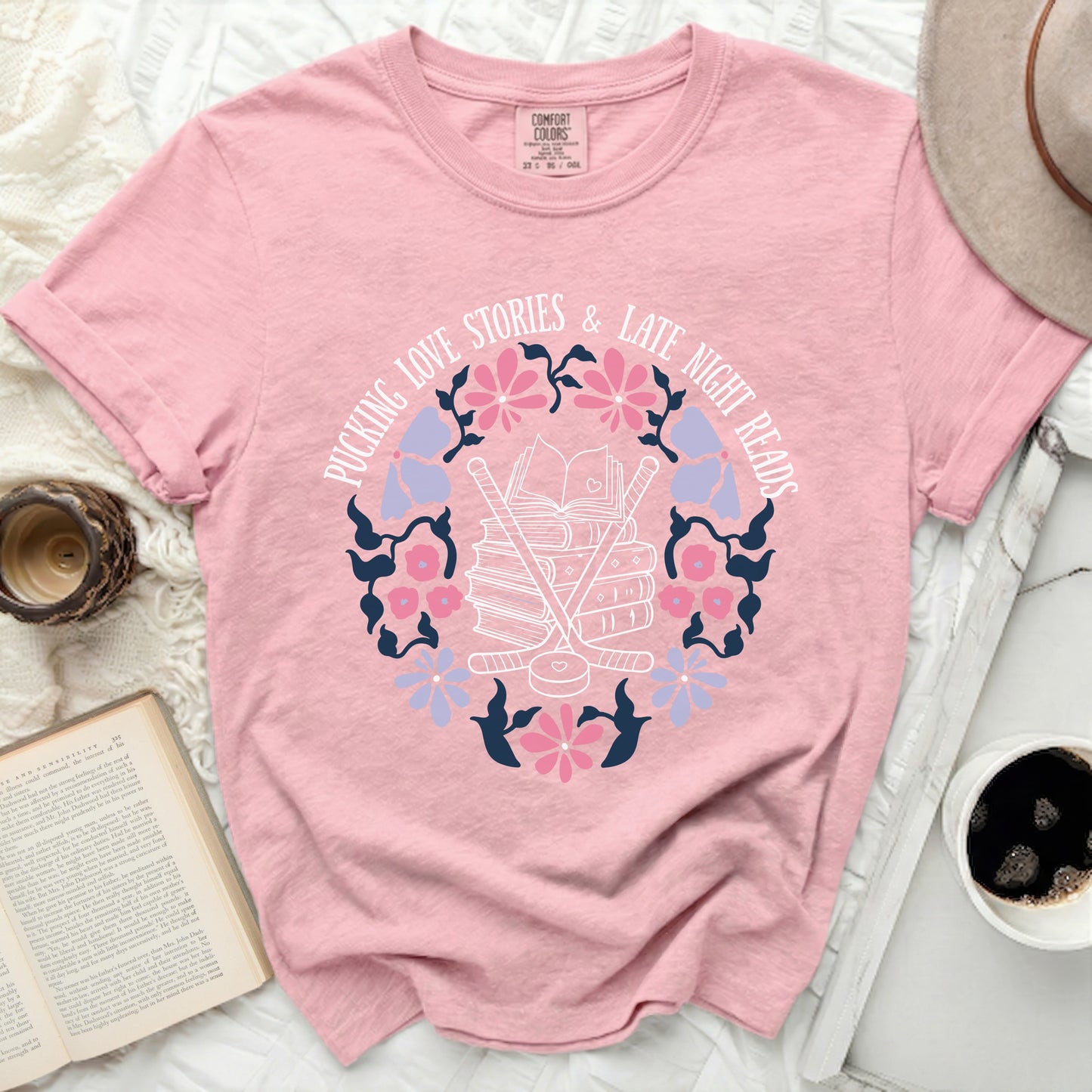 Pink t-shirt with "Pucking Love Stories & Late Night Reads" text and hockey graphic.