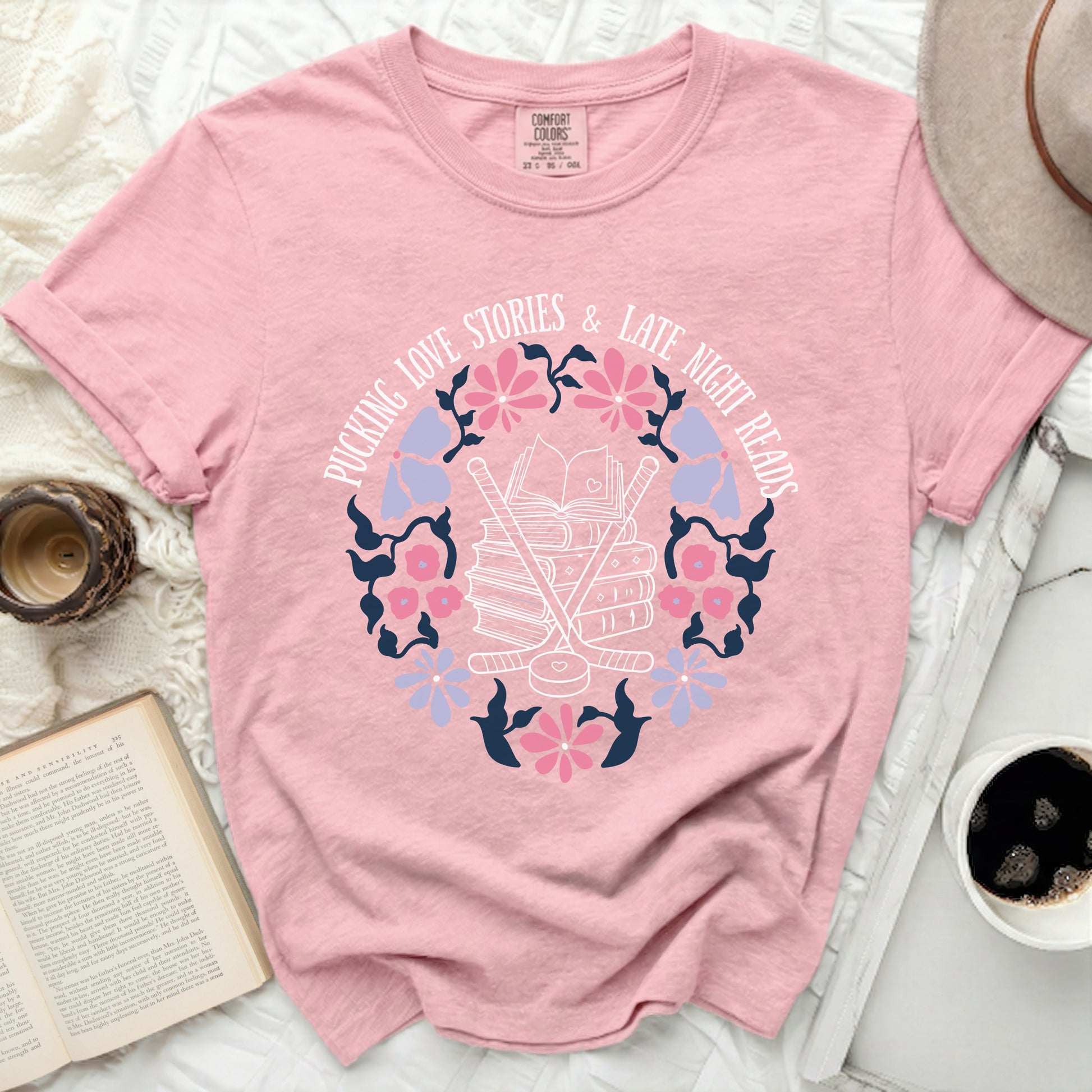 Pink t-shirt with "Pucking Love Stories & Late Night Reads" text and hockey graphic.