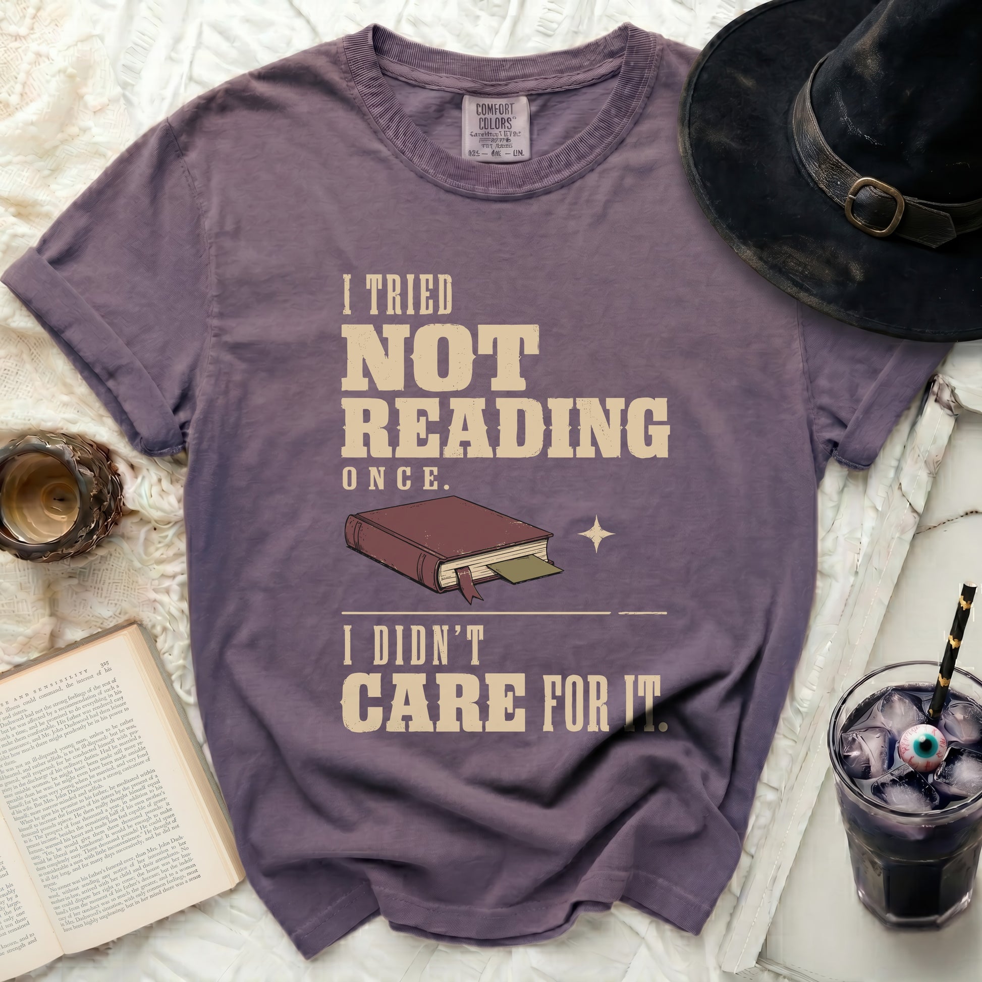Purple t-shirt with "I tried not reading once. I didn't care for it." text.