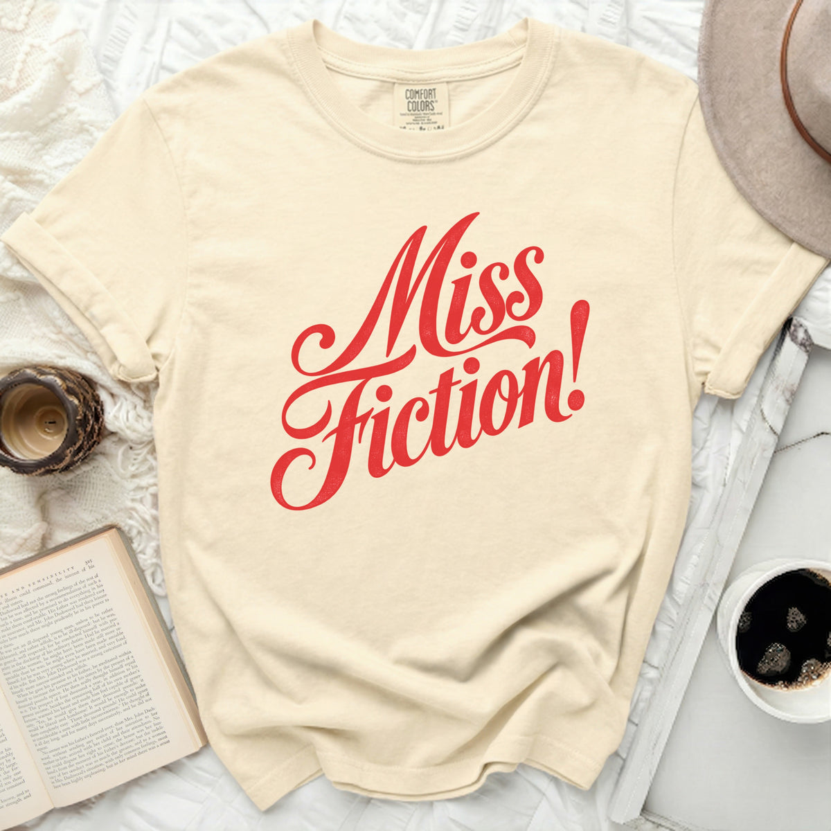 Cream t-shirt with red "Miss Fiction!" graphic print.