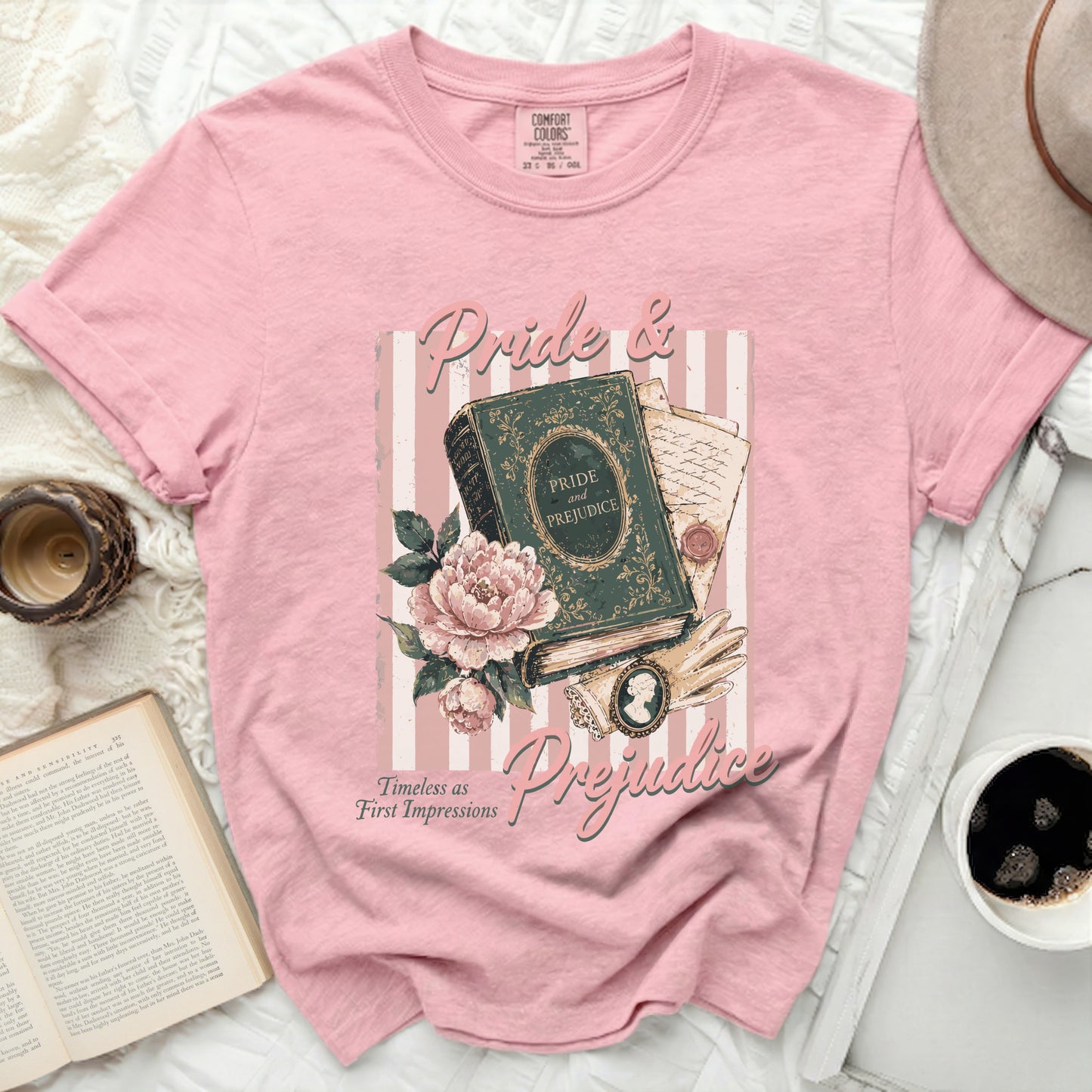 Pink t-shirt with "Pride & Prejudice" book, flowers, and romantic quote graphic.