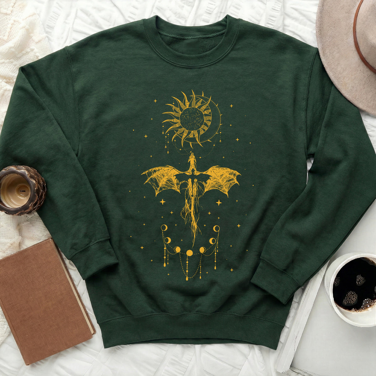 Dark green sweatshirt with yellow dragon, sun, moon phases, and stars graphic.