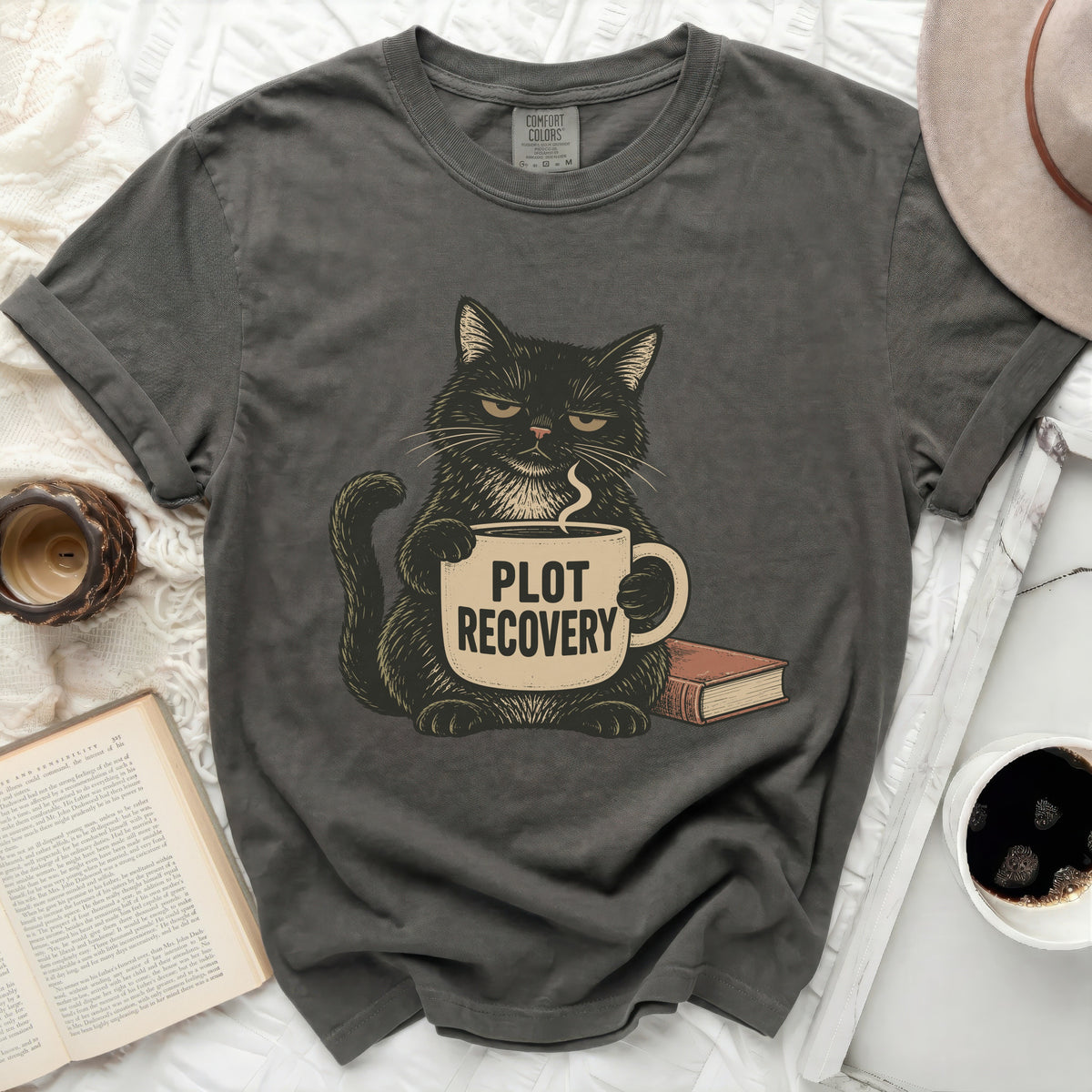 Black cat with grumpy expression holding a coffee mug with text "PLOT RECOVERY".