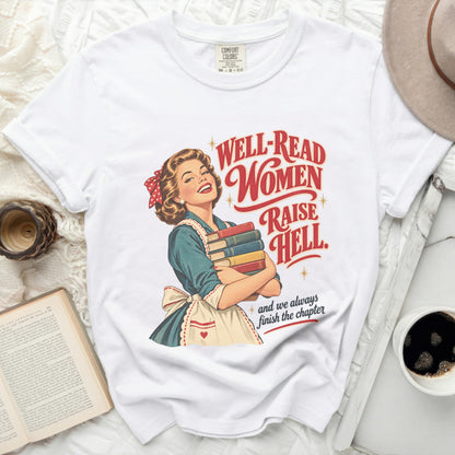 White t-shirt with retro graphic of woman holding books, text "Well-Read Women Raise Hell".