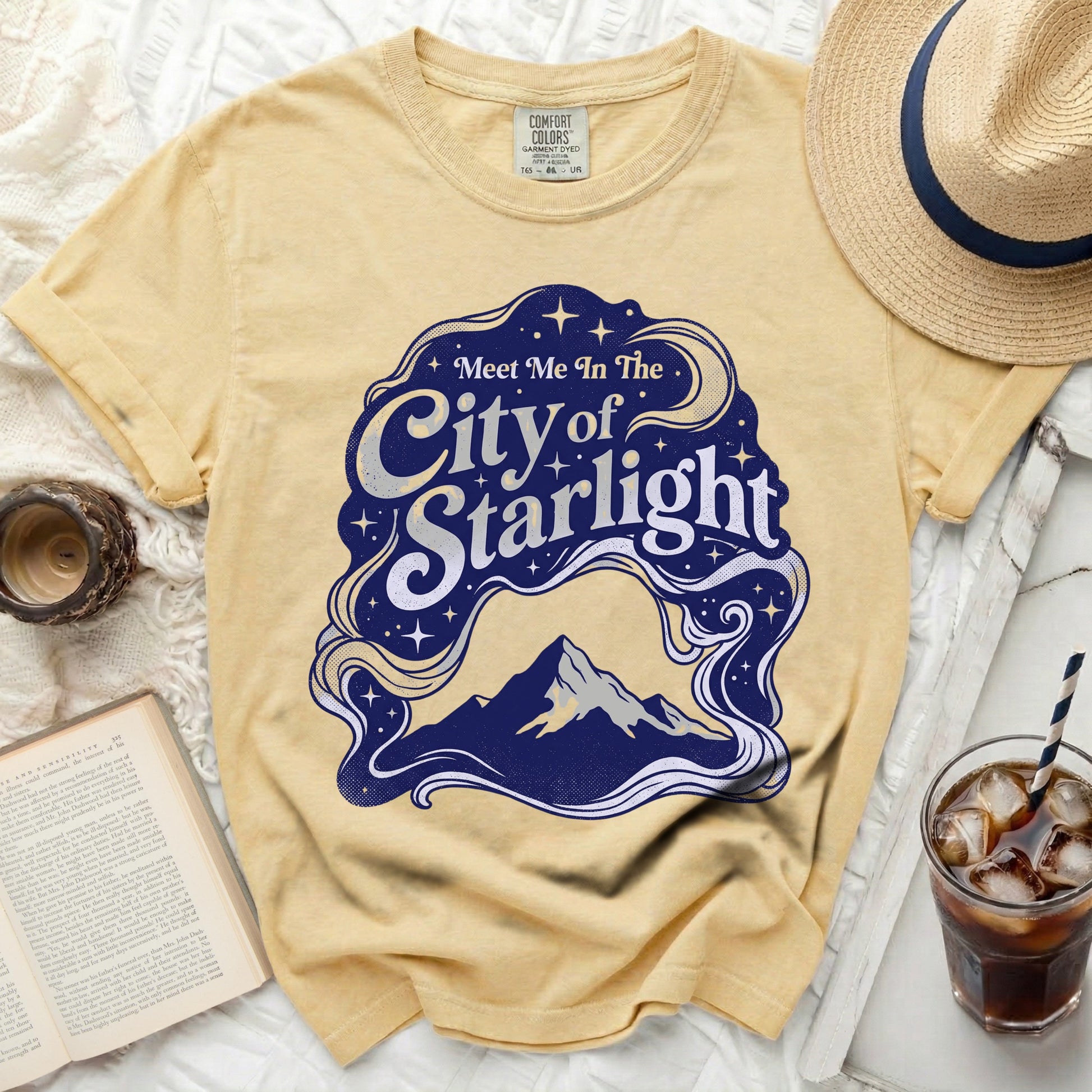 Yellow t-shirt with "Meet Me In The City of Starlight" graphic.