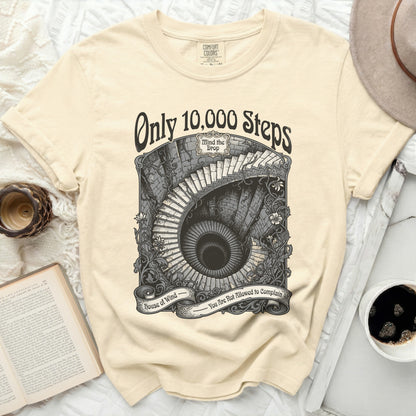 Cream t-shirt with graphic of a spiral staircase, "Only 10,000 Steps", and "House of Wind - You Are Not Allowed to Complain".