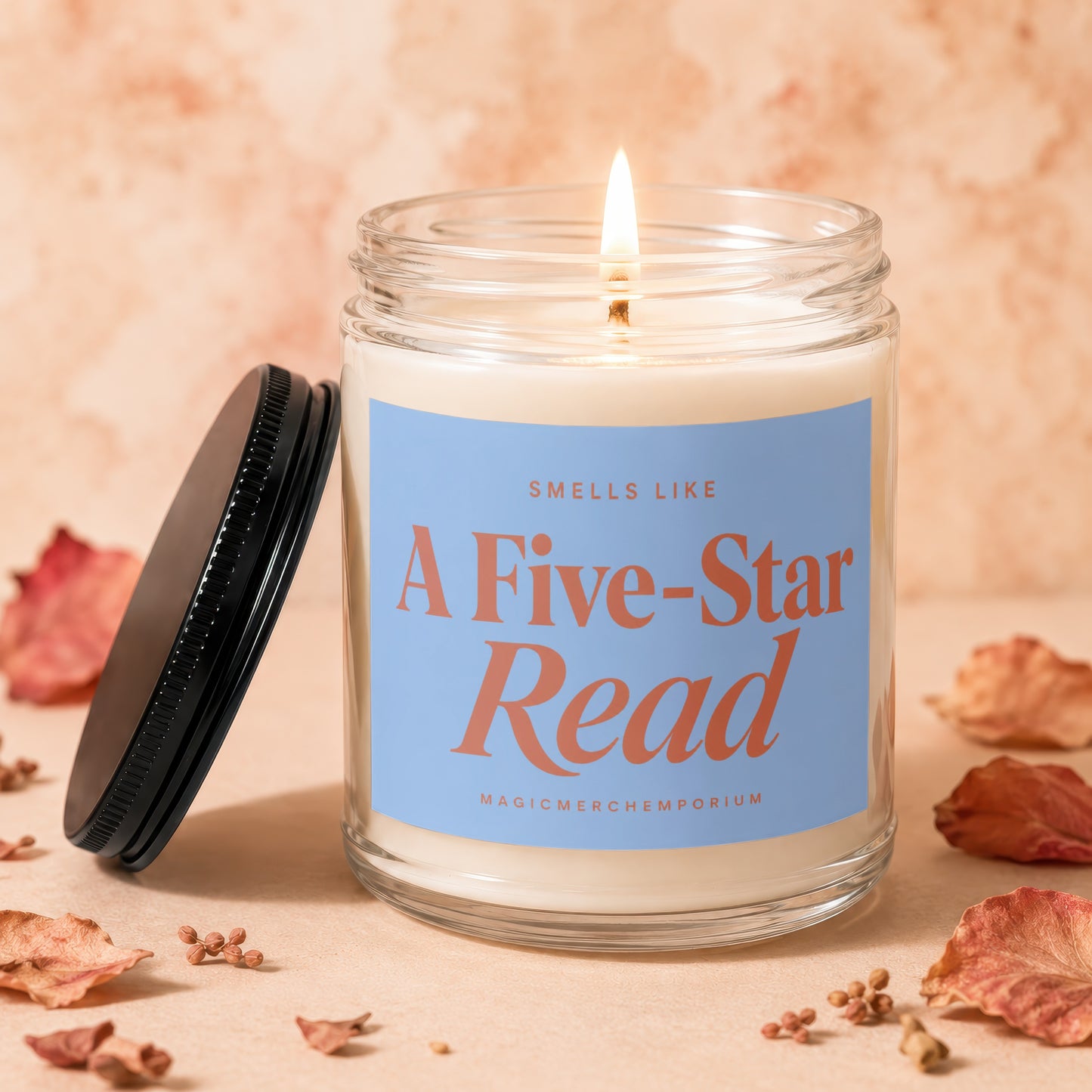 Lit candle in glass jar labeled "Smells Like A Five-Star Read".