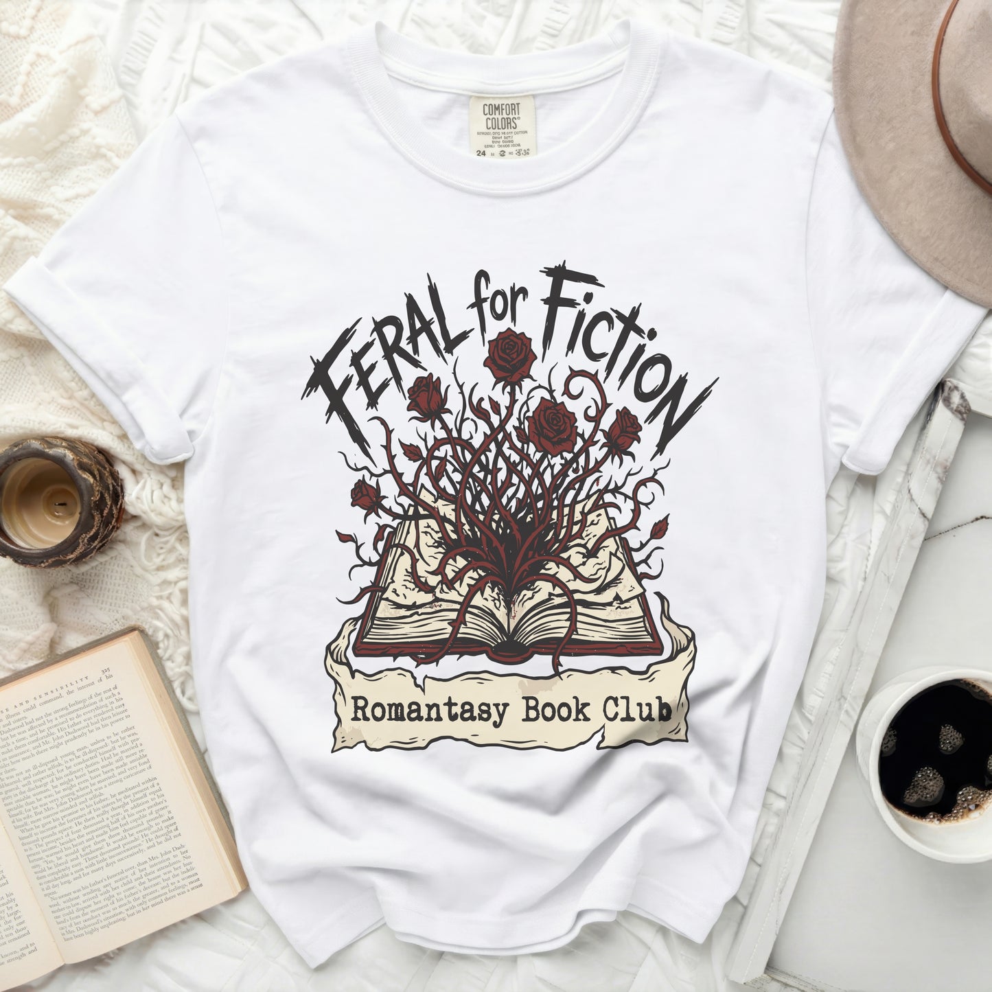White t-shirt with "Feral for Fiction" and "Romantasy Book Club" text.