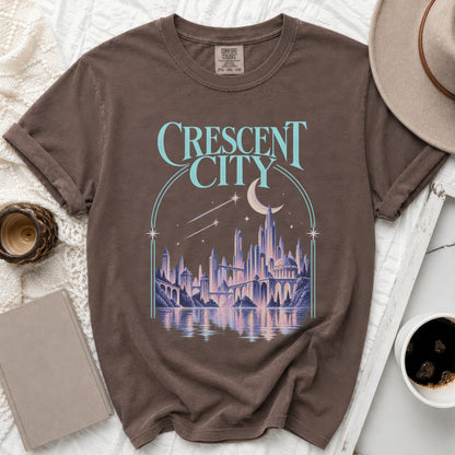 Brown t-shirt with "Crescent City" text and a fantastical city illustration.