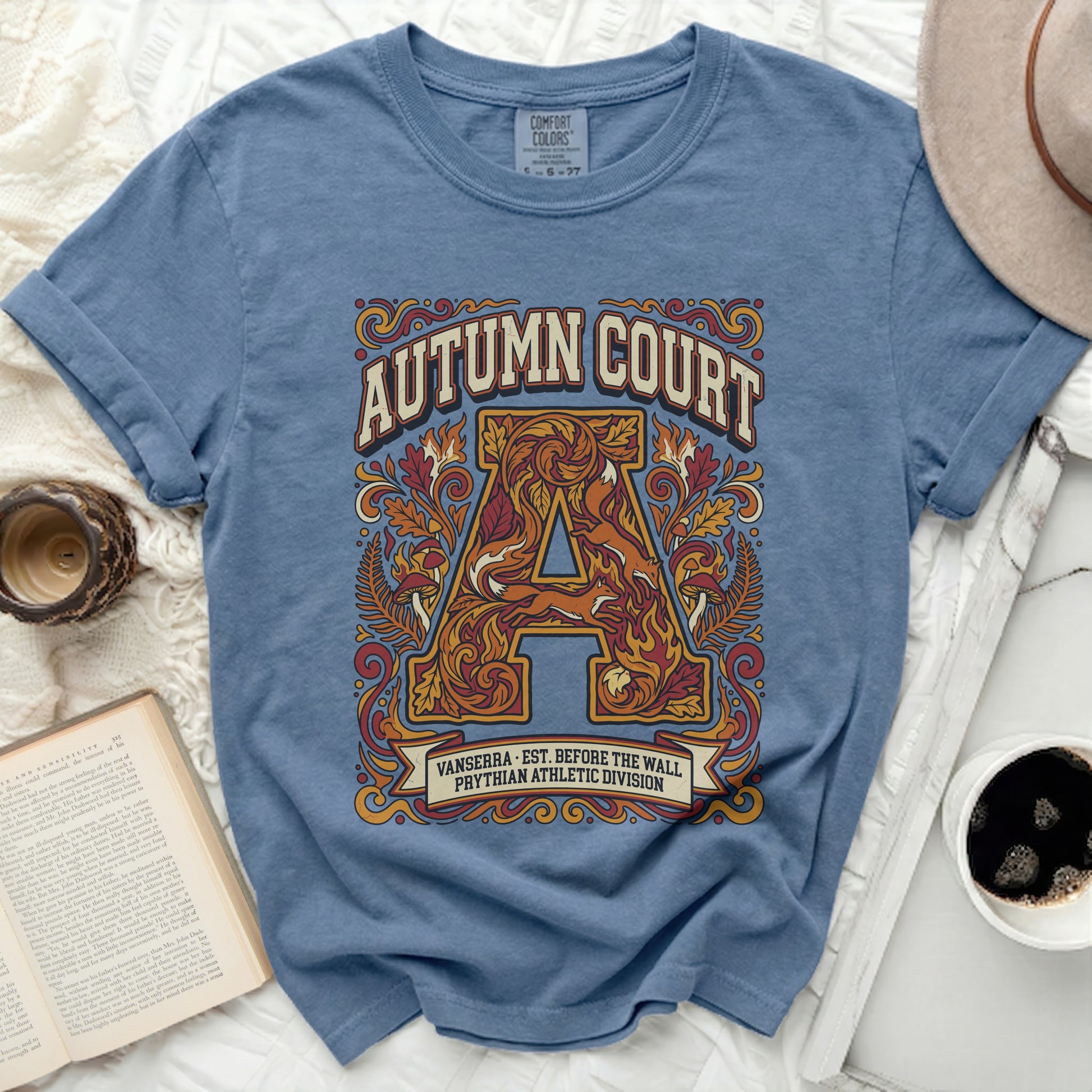 Blue t-shirt with "Autumn Court" athletic graphic featuring an ornate "A" and foxes.