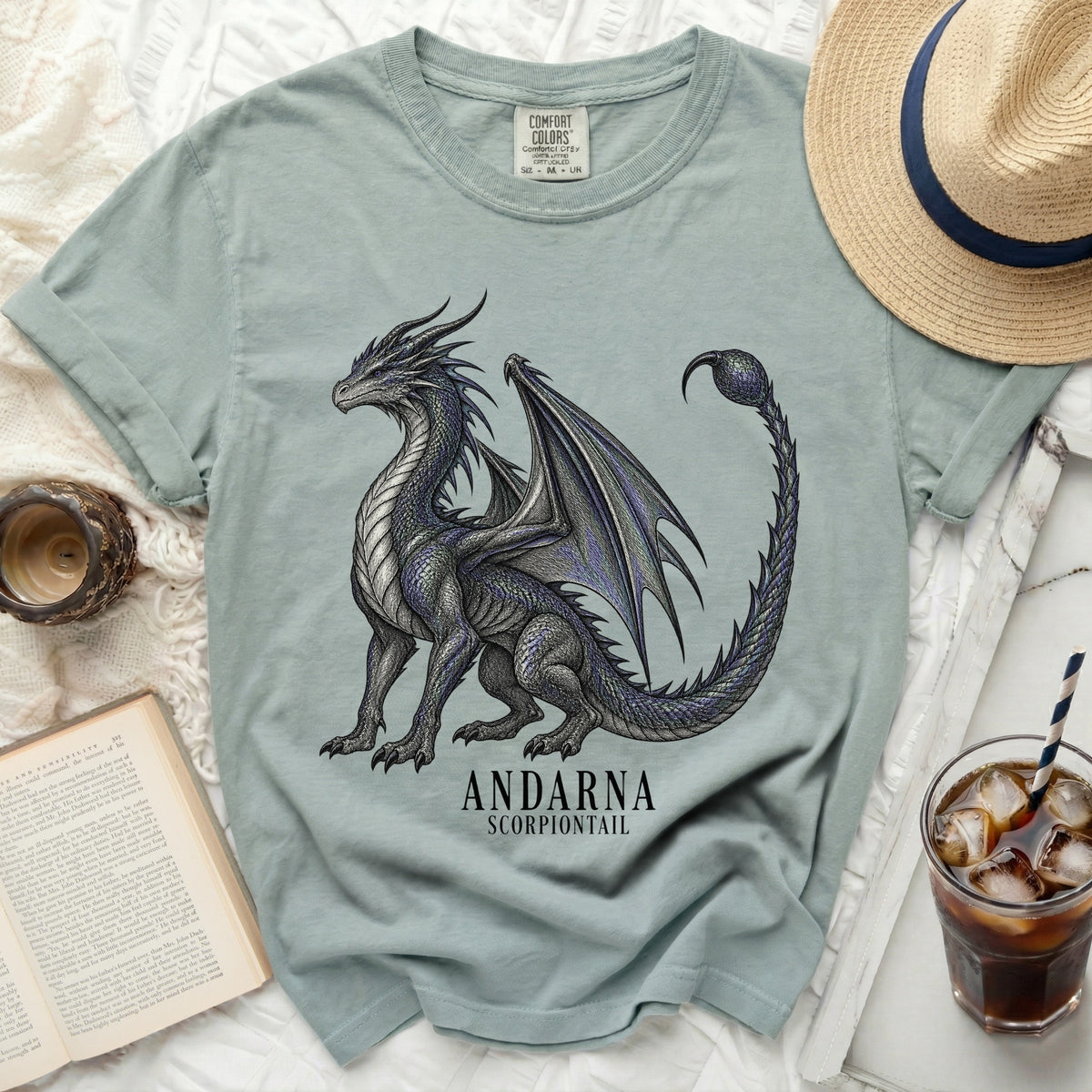 Light teal t-shirt with a black and blue dragon graphic and text "ANDARNA SCORPIONTAIL".